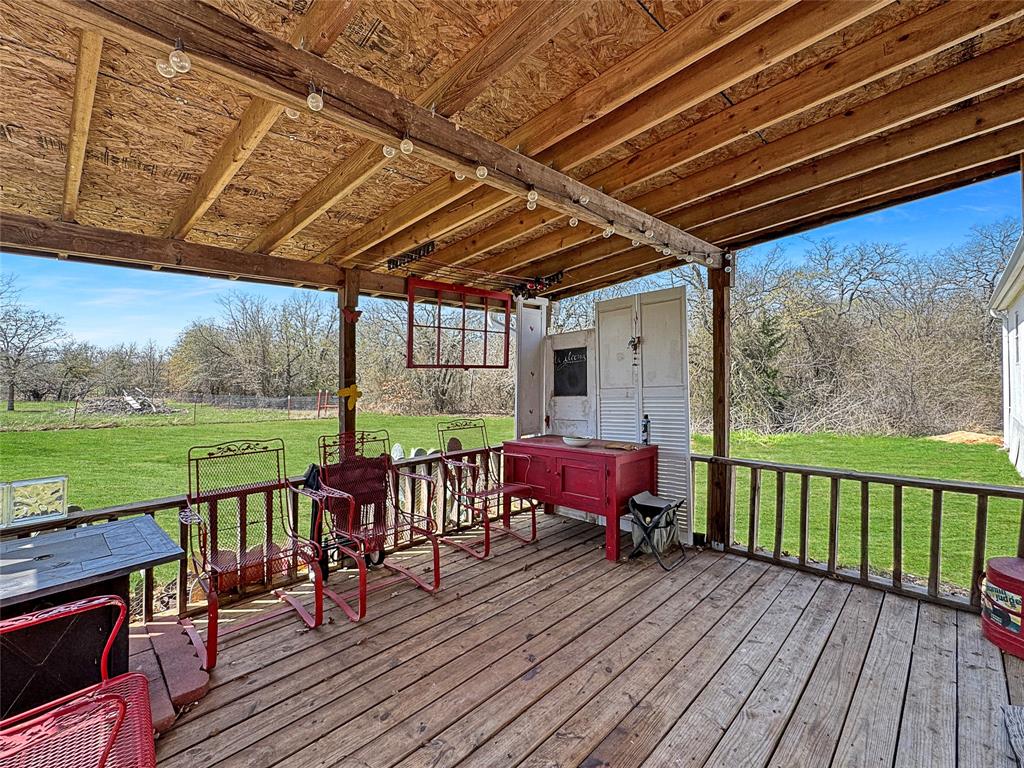 1791 County Road 3855 Poolville, TX 76487 - Photo 6 of 31 a view of a wooden deck with furniture