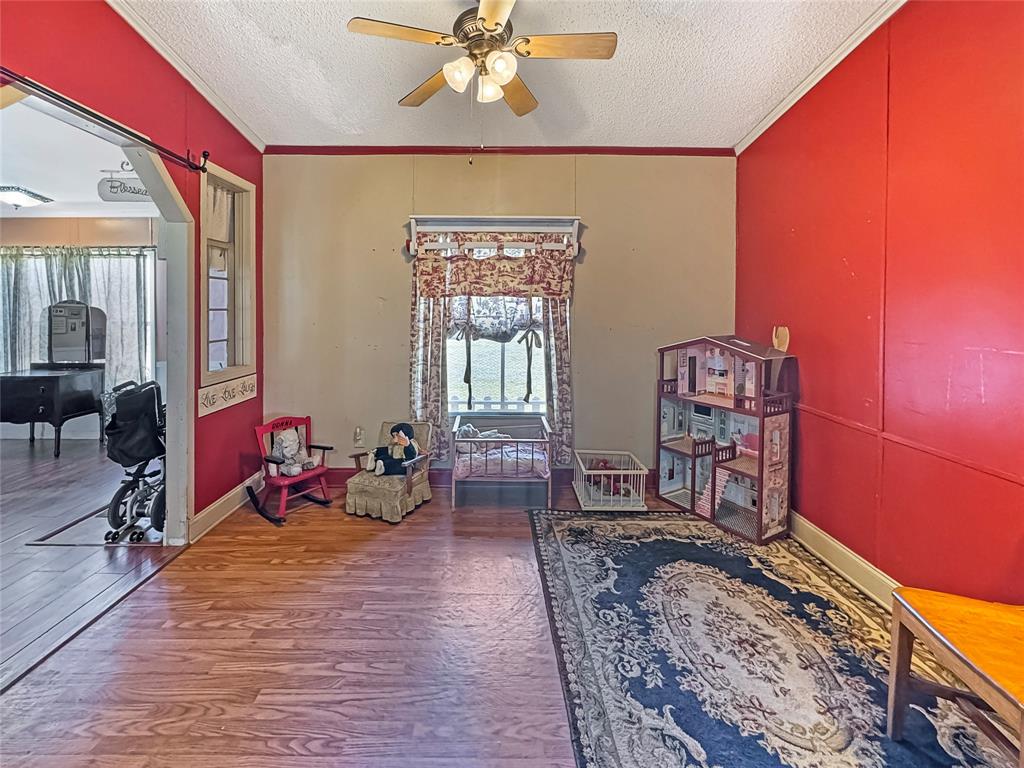 1791 County Road 3855 Poolville, TX 76487 - Photo 9 of 31 a living room with furniture a dining table and large windows