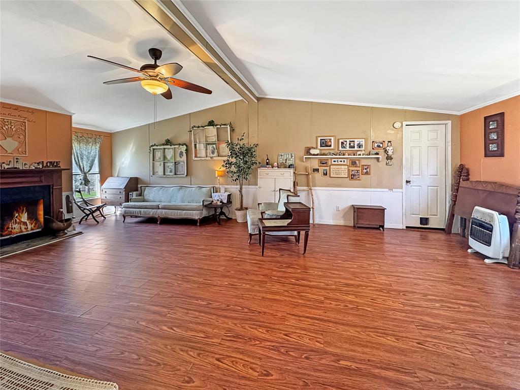 1791 County Road 3855 Poolville, TX 76487 - Photo 10 of 31 a living room with furniture and a fireplace