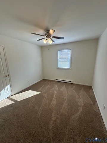 an empty room with a window and a ceiling fan