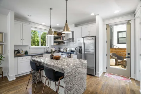 a kitchen with refrigerator cabinets dining table and chairs