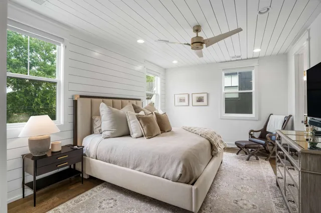 a bedroom with bed window and couch