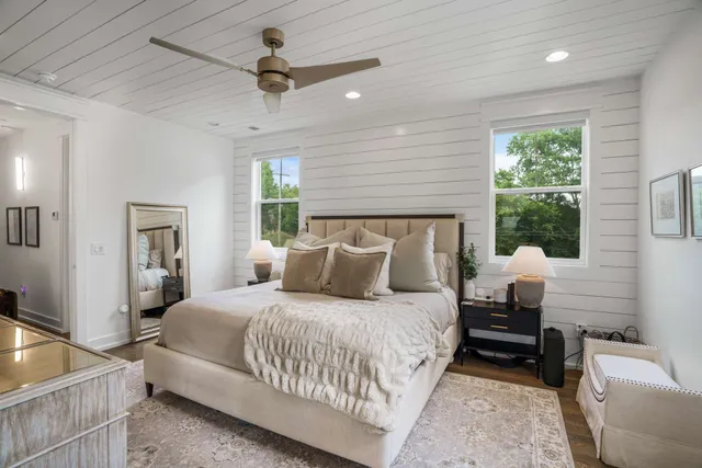 a bedroom with bed and a chandelier
