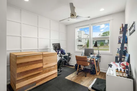 a bedroom with furniture and a large window