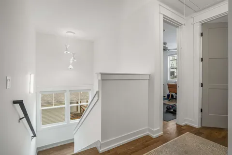 a view of entryway with wooden floor and stairs
