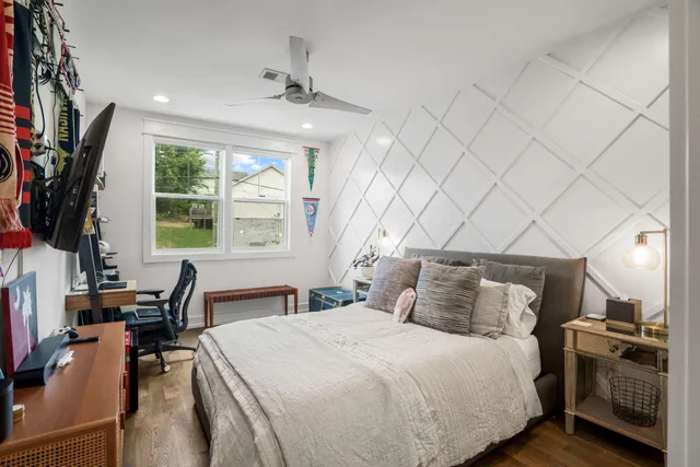 a bedroom with a large bed and a window