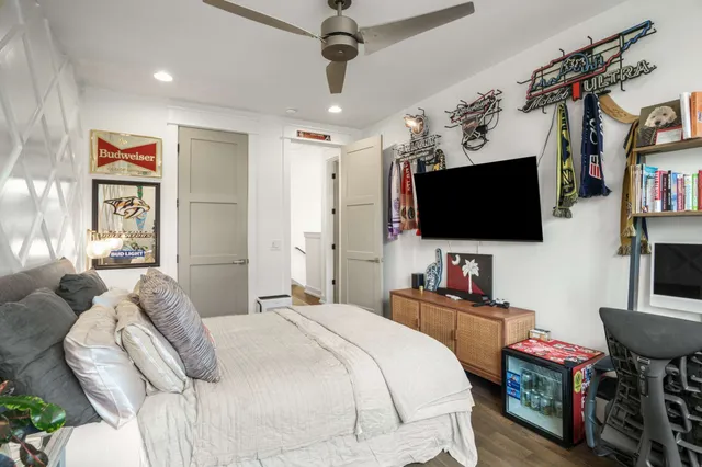 a bedroom with a bed and a flat screen tv