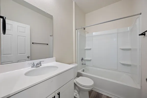 a bathroom with a sink toilet a mirror and shower
