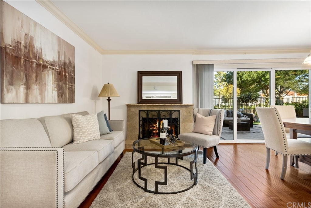 4625 Green Tree Lane Irvine, CA 92612 - Photo 13 of 51 a living room with furniture a fireplace and a large window