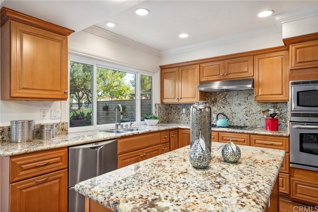 4625 Green Tree Lane Irvine, CA 92612 - Photo 16 of 51 a kitchen with stainless steel appliances granite countertop a sink stove and cabinets