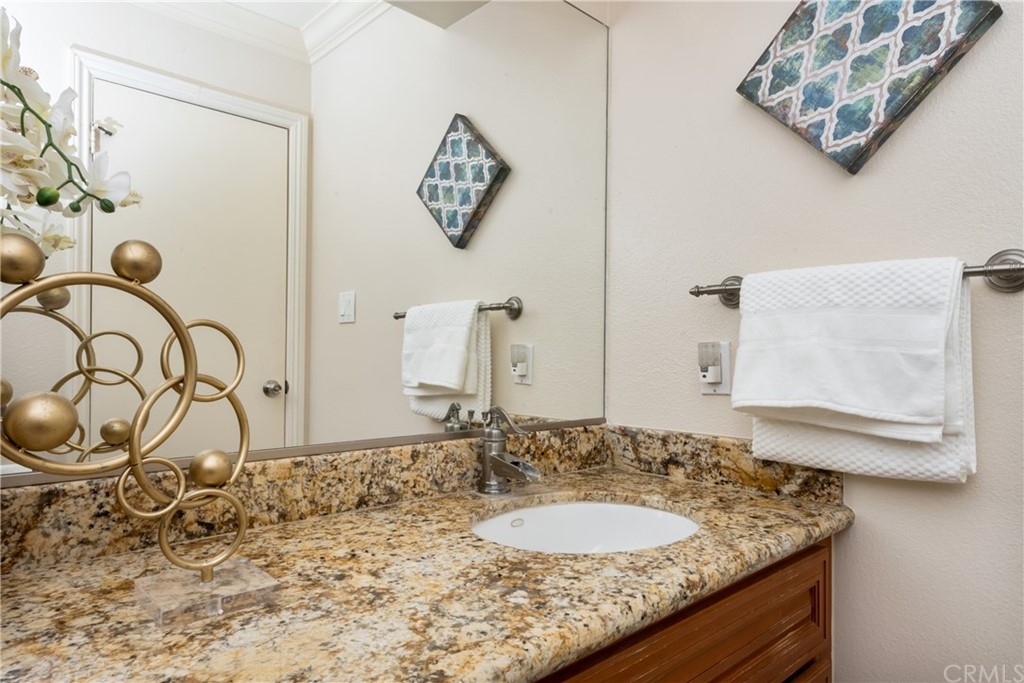 4625 Green Tree Lane Irvine, CA 92612 - Photo 21 of 51 a bathroom with a granite countertop sink and a mirror