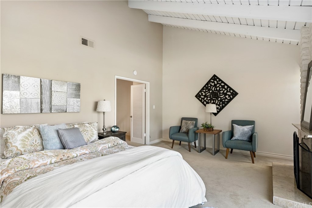 4625 Green Tree Lane Irvine, CA 92612 - Photo 24 of 51 a spacious bedroom with a bed a table and chair