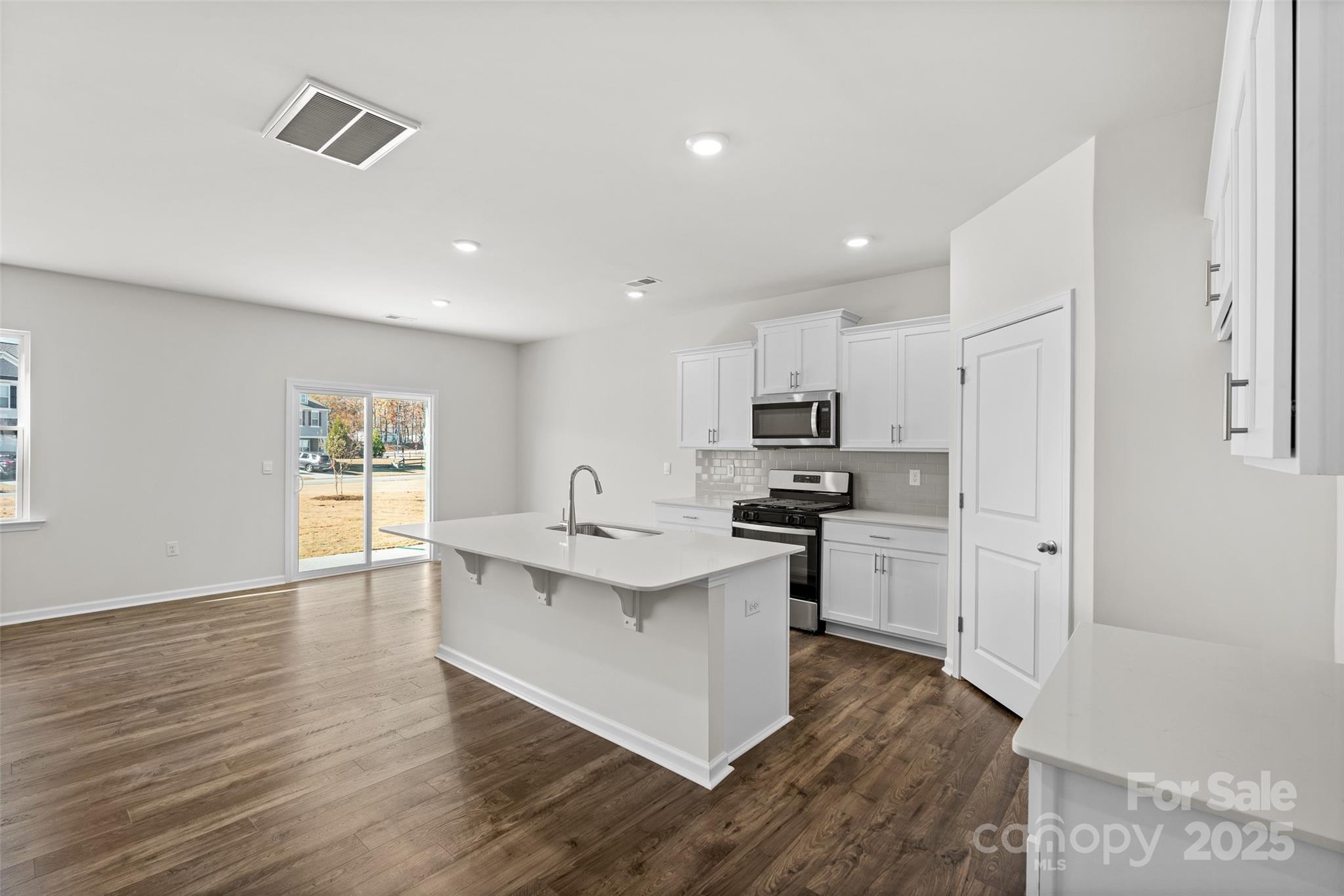97 Salers Road Fletcher, NC 28732 - Photo 7 of 28 a kitchen with stainless steel appliances a sink stove and refrigerator