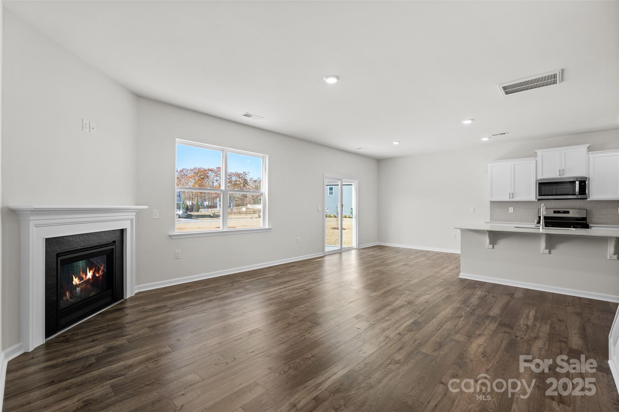 97 Salers Road Fletcher, NC 28732 - Photo 8 of 28 a view of empty room with wooden floor and fireplace