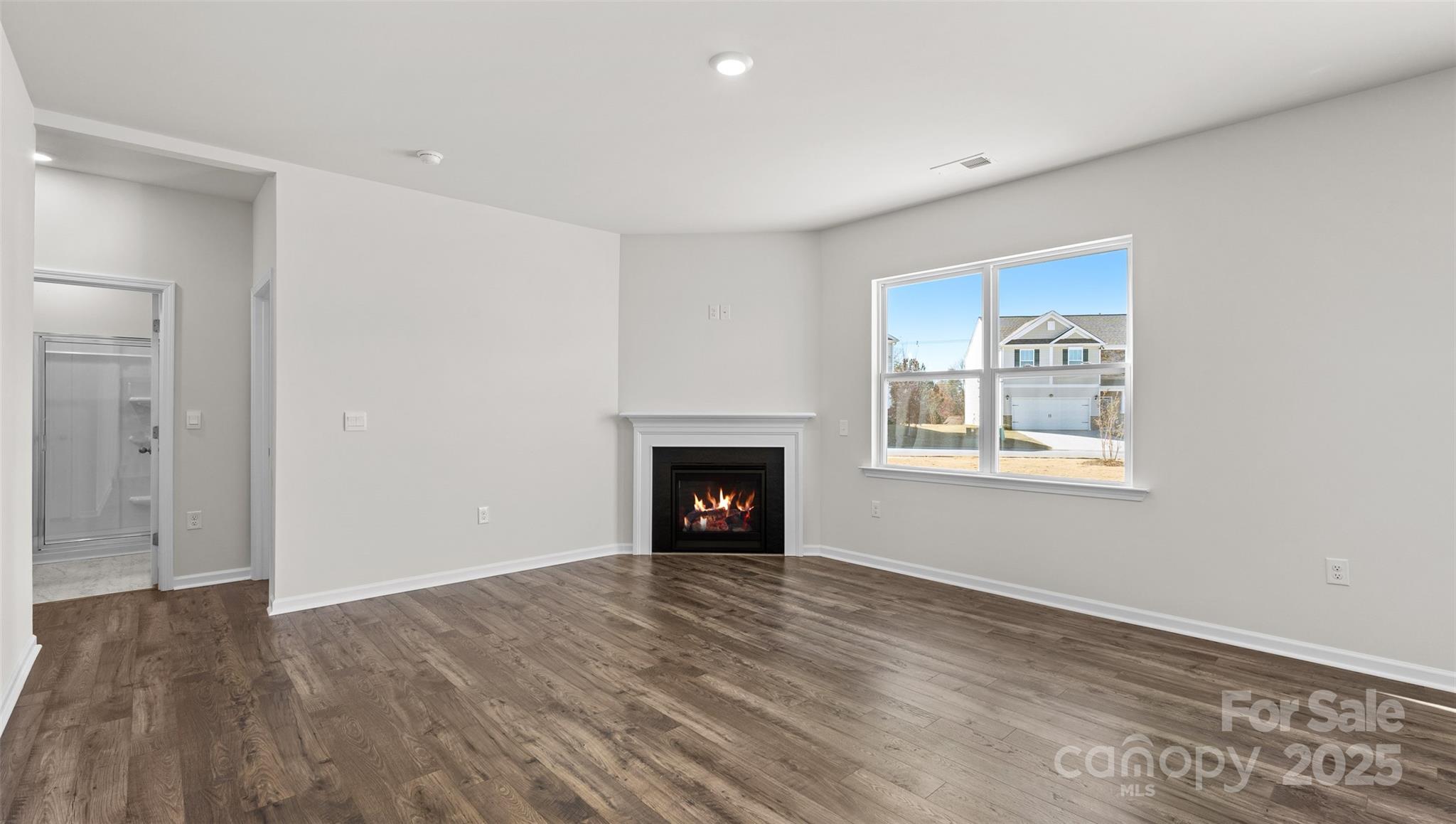97 Salers Road Fletcher, NC 28732 - Photo 9 of 28 a view of a livingroom with a fireplace wooden floor and window