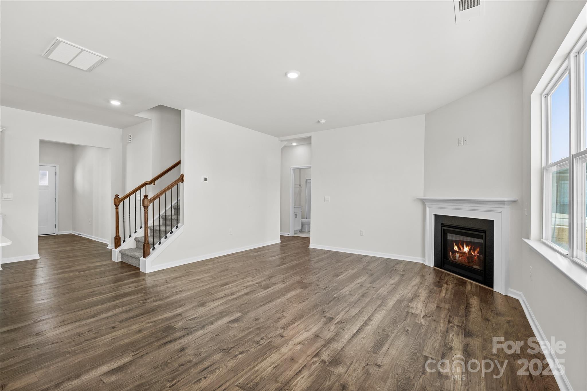 97 Salers Road Fletcher, NC 28732 - Photo 10 of 28 a view of an empty room with wooden floor fireplace and a window