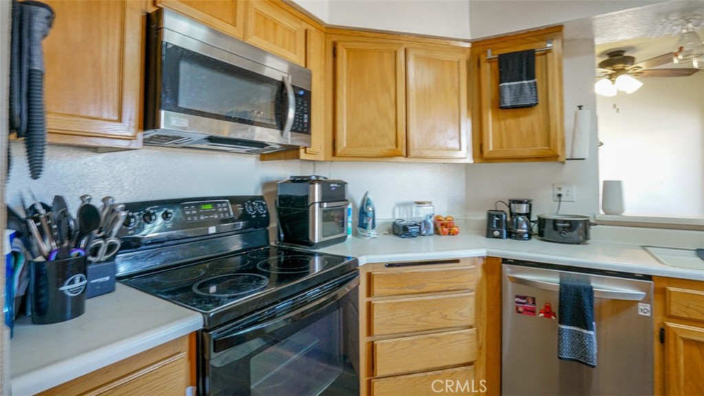 7641 Reseda Boulevard, Unit 128Z Reseda, CA 91335 - Photo 17 of 44 a kitchen with a stove and a microwave