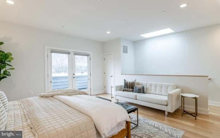 628 I Street Northeast, Unit 3 Washington, DC 20002 - Photo 22 of 32 a spacious bedroom with a bed and a couch