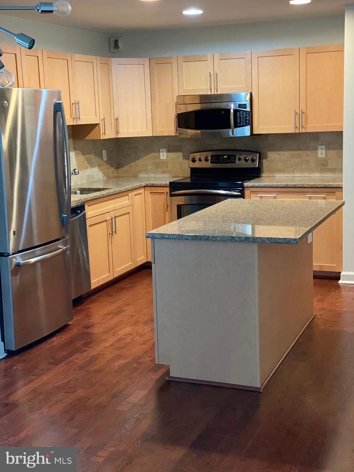 901 North Penn Street, Unit F207 Philadelphia, PA 19123 - Photo 2 of 12 a kitchen with a appliances a sink and a microwave