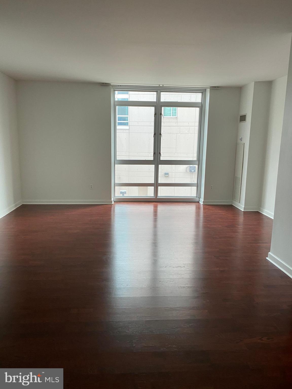 901 North Penn Street, Unit F207 Philadelphia, PA 19123 - Photo 3 of 12 a view of an empty room with wooden floor and a window