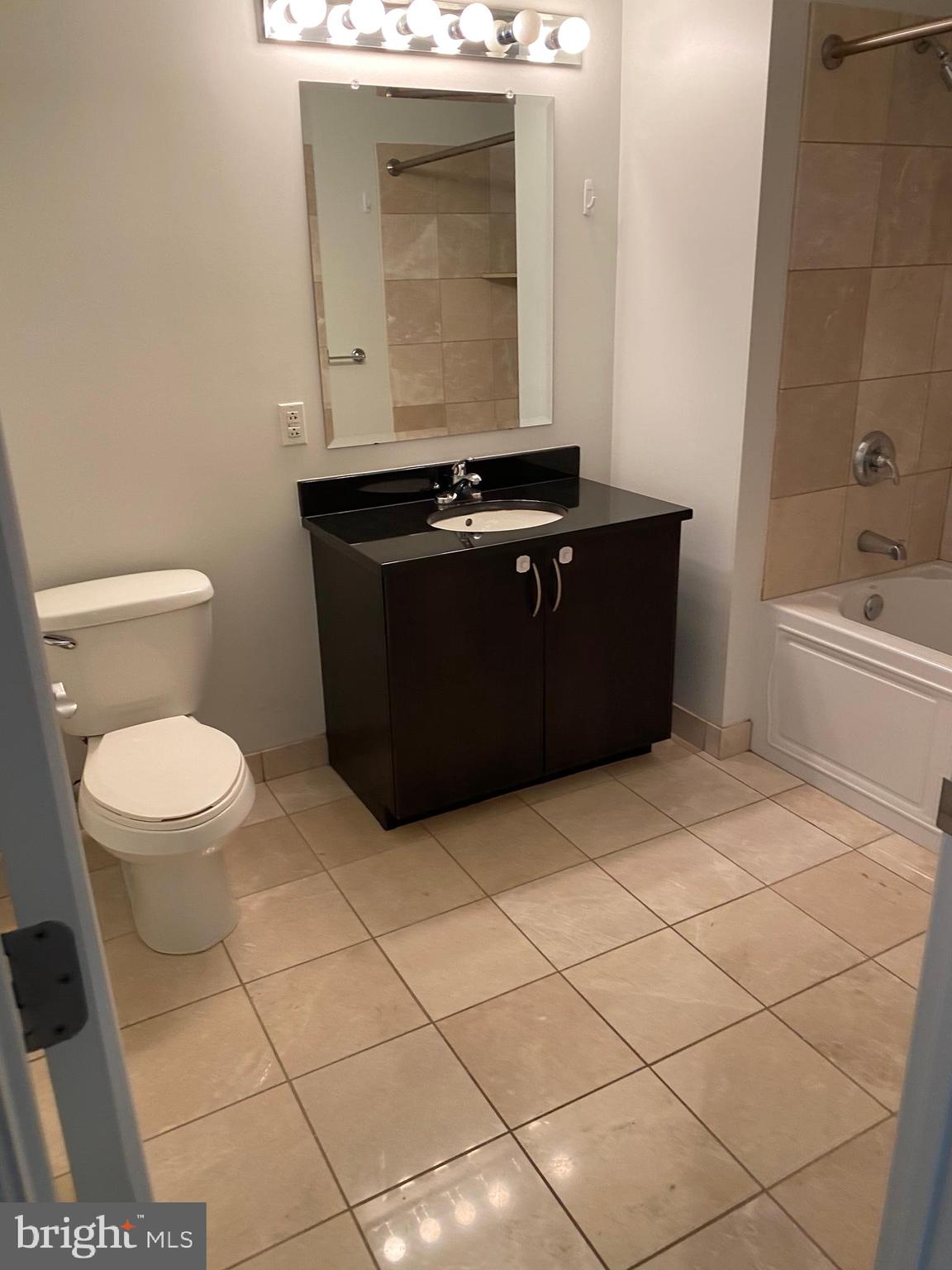901 North Penn Street, Unit F207 Philadelphia, PA 19123 - Photo 7 of 12 a bathroom with a sink a toilet and mirror