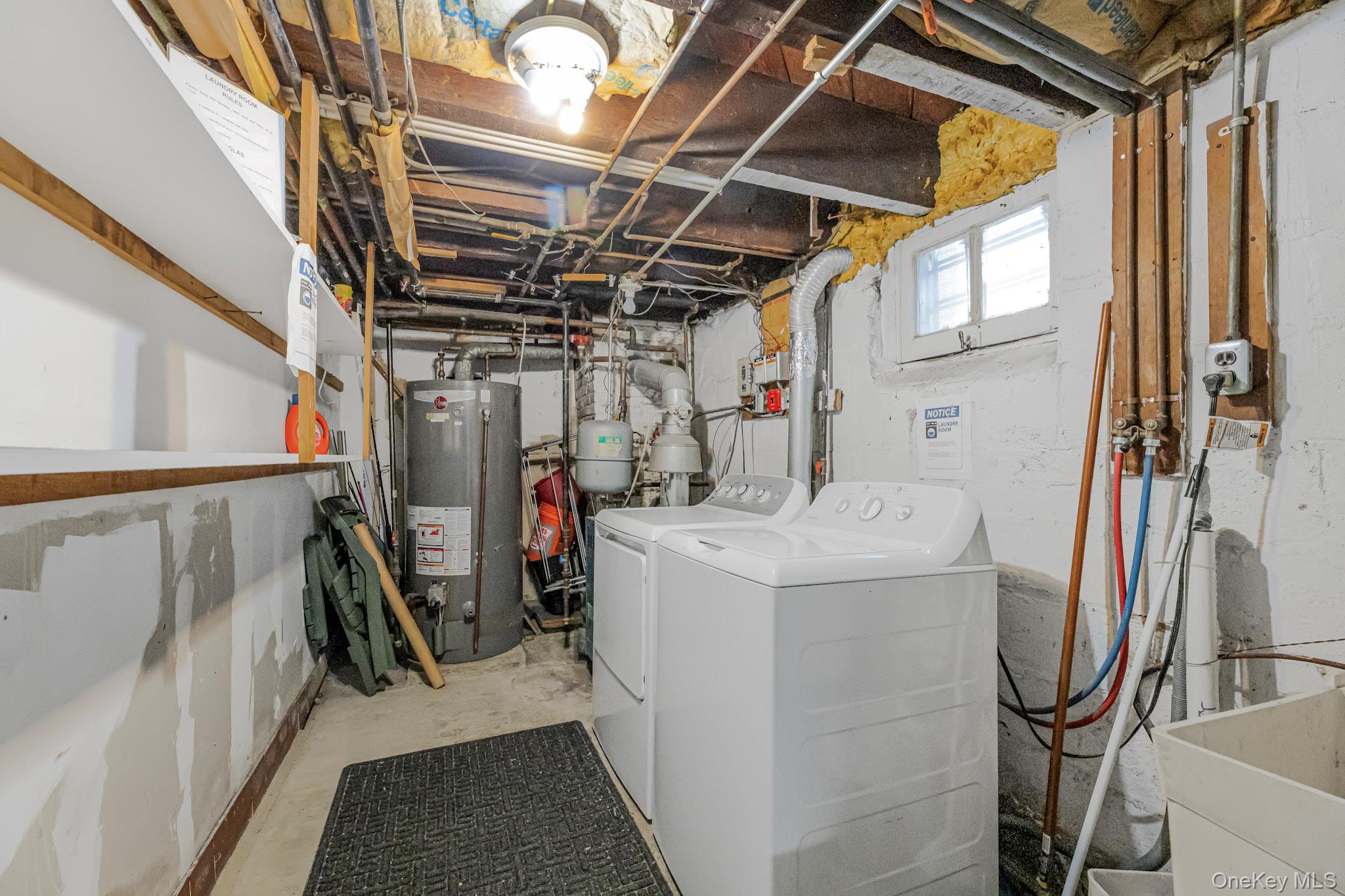 168 Stephenson Boulevard New Rochelle, NY 10801 - Photo 8 of 21 Laundry room with gas water heater, washing machine and dryer, and concrete floors