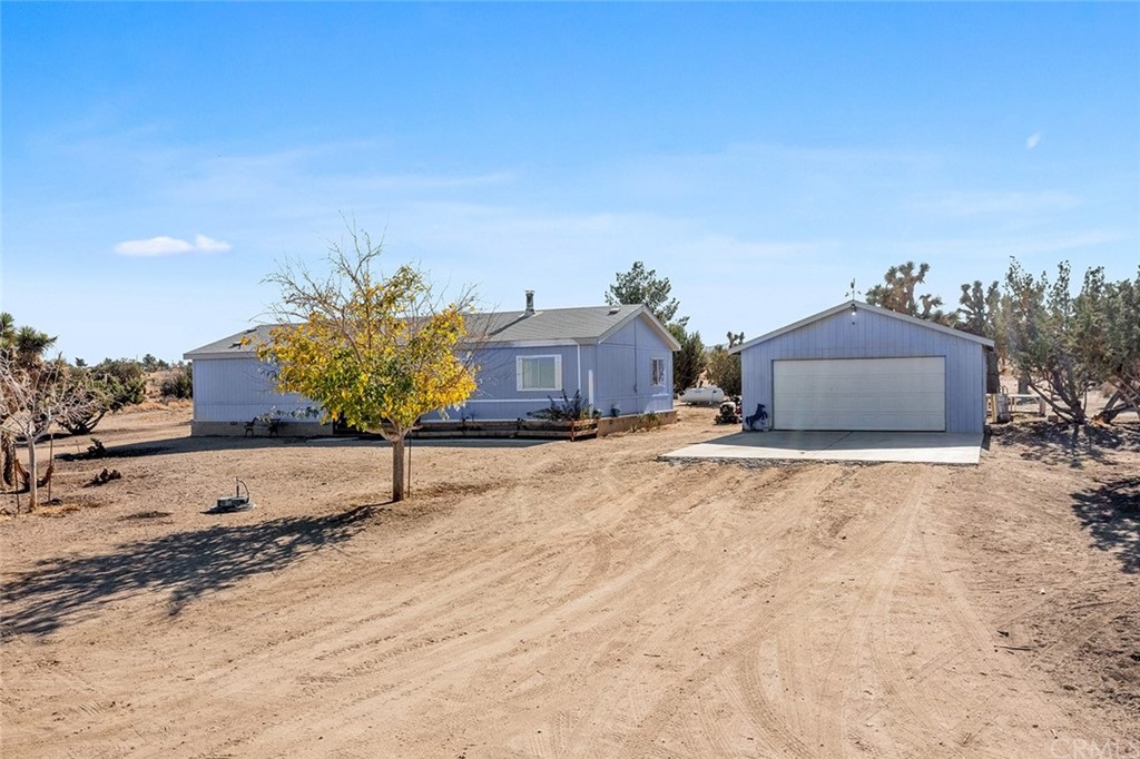 5839 Smoke Tree Road, Unit B Phelan, CA 92371 - Photo 1 of 1 a view of a house with a yard and garage