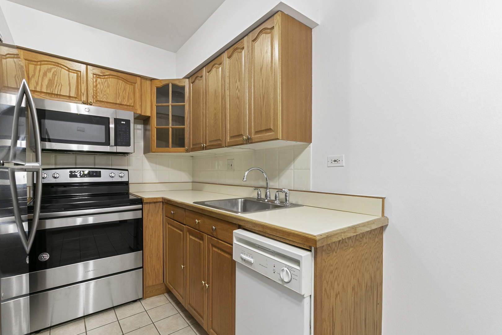1130 Dunlop Avenue, Unit 2C Forest Park, IL 60130 - Photo 6 of 15 a kitchen with a sink stove and microwave