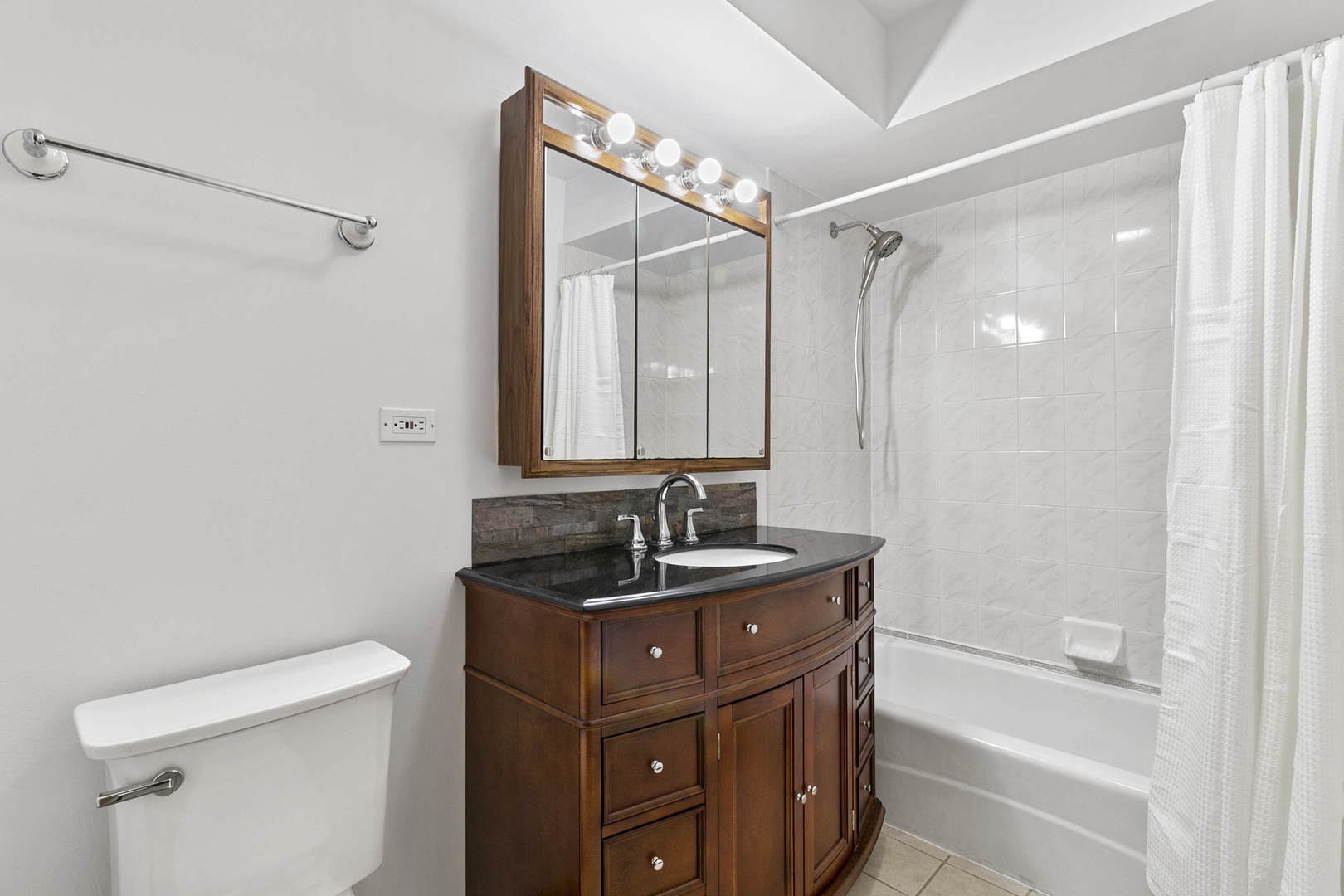1130 Dunlop Avenue, Unit 2C Forest Park, IL 60130 - Photo 9 of 15 a bathroom with a granite countertop sink toilet and shower