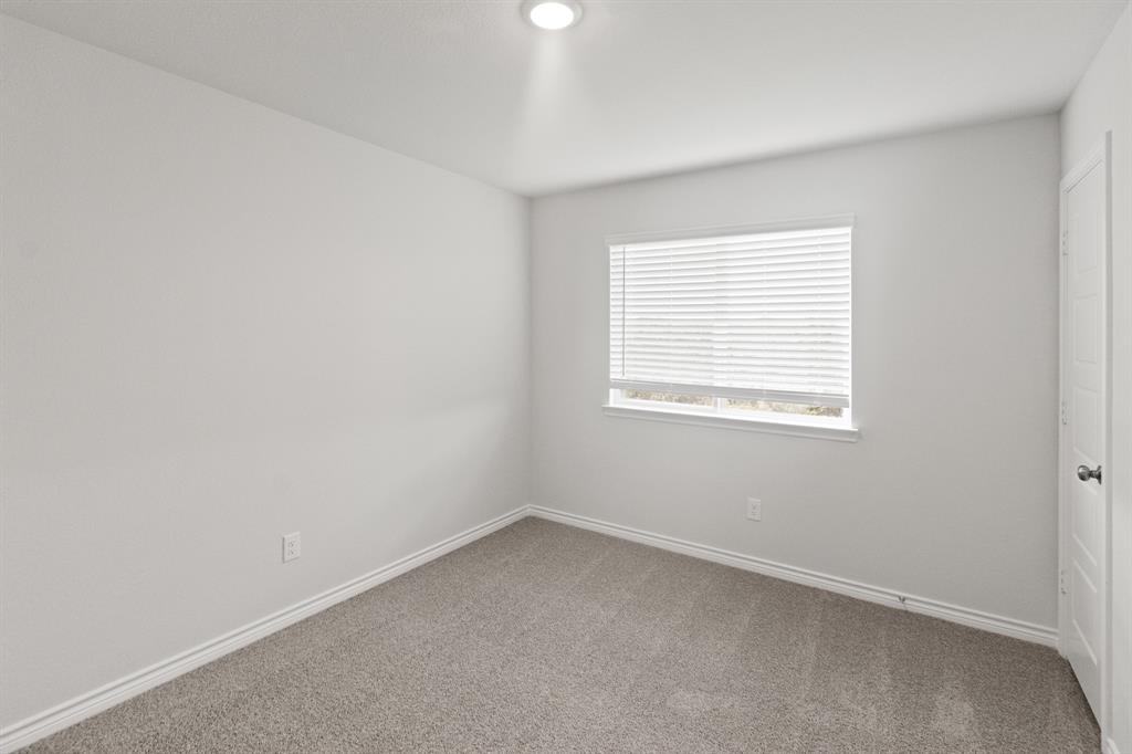 1606 Romans Road Ennis, TX 75119 - Photo 14 of 16 an empty room with a window