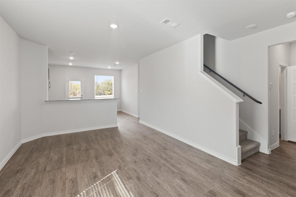 1606 Romans Road Ennis, TX 75119 - Photo 4 of 16 a view of an empty room with wooden floor and a window