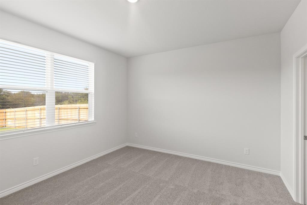 1606 Romans Road Ennis, TX 75119 - Photo 9 of 16 an empty room with a window