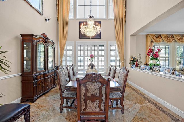 a view of a dining room with furniture and chandelier