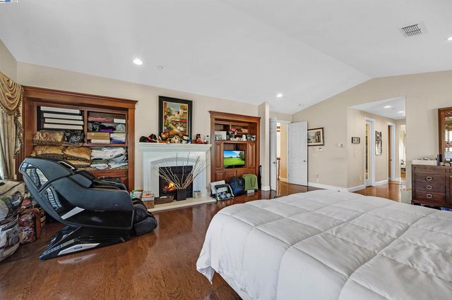 a bed room with a bed and a fireplace