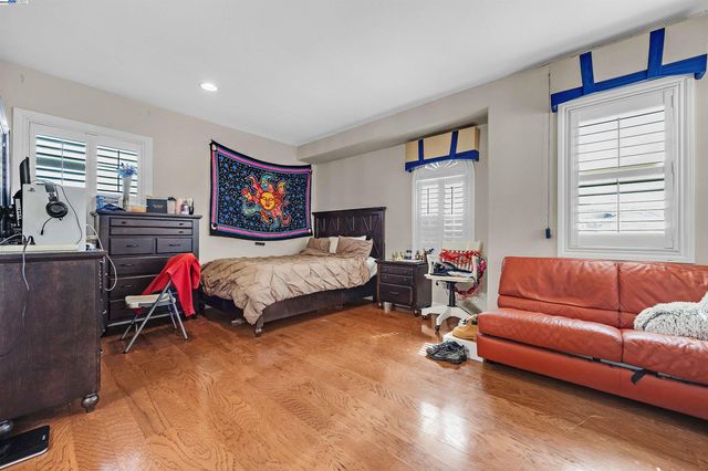 a bedroom with furniture and a flat screen tv