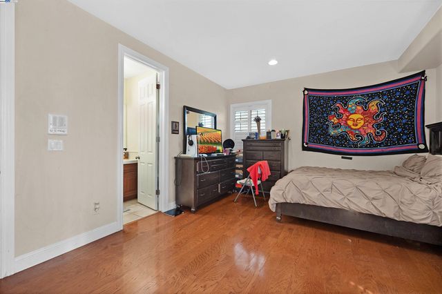 a bathroom with a granite countertop sink a toilet and shower