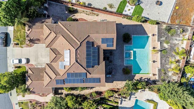 a view of a house with swimming pool and sitting area