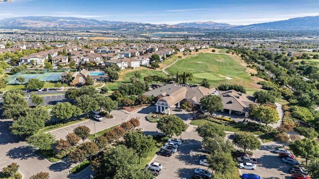 an aerial view of residential houses with outdoor space and river