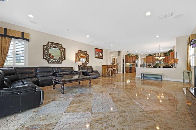 a living room with lots of furniture and kitchen view
