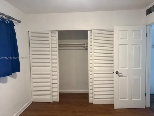 a bathroom with a granite countertop sink a toilet and a mirror