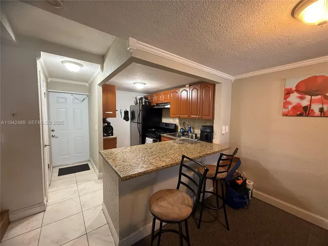 a view of a kitchen with kitchen island dining table and chairs