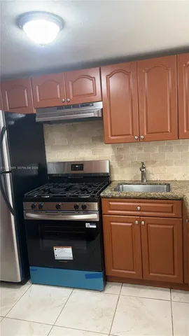 a stove top oven sitting inside of a kitchen