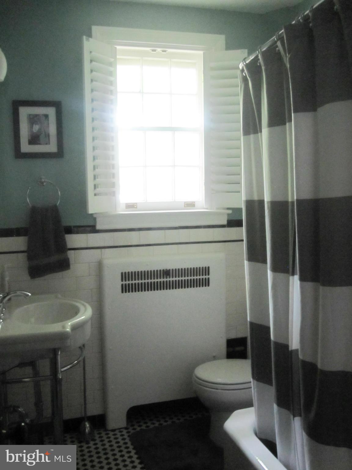 303 Murdock Road Baltimore, MD 21212 - Photo 14 of 25 a bathroom with a sink toilet and shower