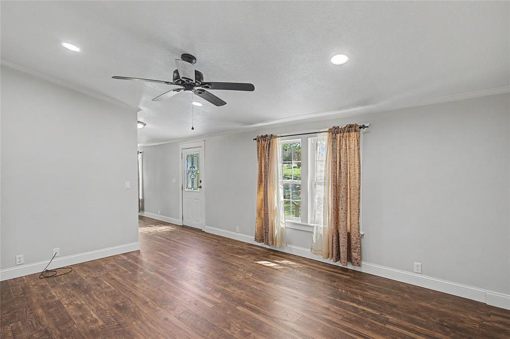 1701 Central Road Weatherford, TX 76088 - Photo 9 of 40 Living room with crown molding, a ceiling fan, dark wood-style flooring, and recessed lighting and a view of the entry.