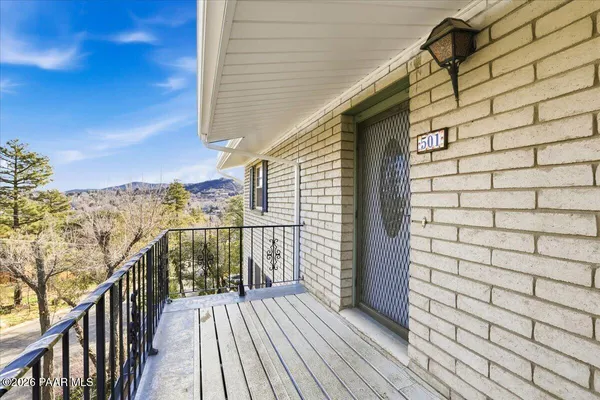 a view of a balcony with wooden floor and stairs