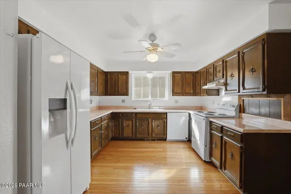 a large kitchen with stainless steel appliances granite countertop a stove refrigerator sink and dishwasher