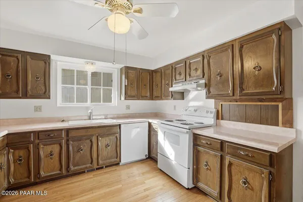 a kitchen with a sink stove and cabinets