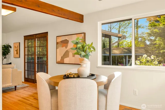 a dining room with furniture and wooden floor