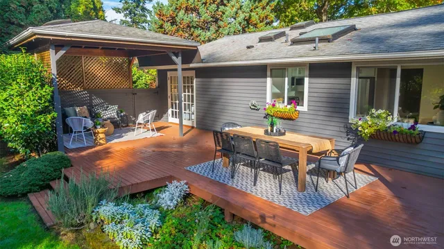 a view of a patio with a table and chairs and potted plants