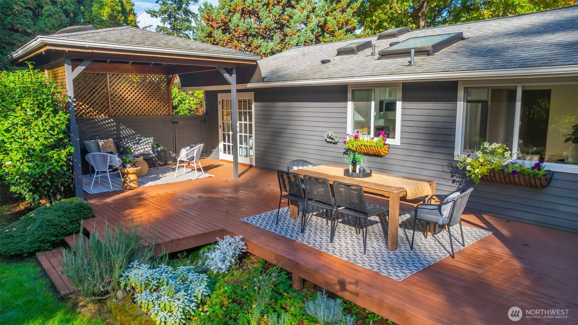 4730 228th Street Southeast Bothell, WA 98021 - Photo 17 of 37 a view of a patio with table and chairs potted plants with wooden floor